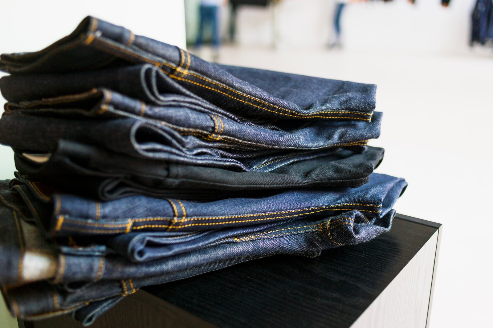 Stack of new jeans in factory